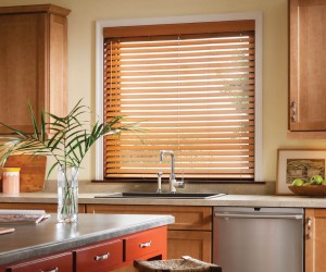 Window over kitchen sink with wood blinds pulled down and turned open