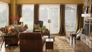 drapery treatment on shuttered windows of a large living room of a house