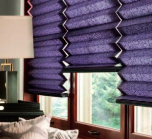 Purple pleated shades covering wooden-framed windows in living room