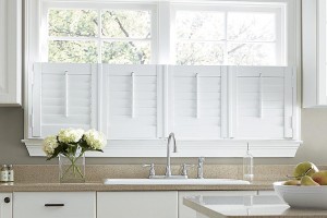 white composite plantation shutters over a kitchen sink